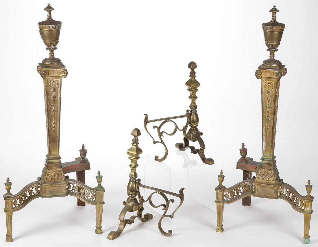 A PAIR OF ORNATE BRASS ANDIRONS 19TH C: A PAIR OF ORNATE BRASS ANDIRONS 19TH C. Finely constructed of classical design, tapered legs and columns surmounted with urn finials, ram's head corners and bell flowers. Together with an earlier pair