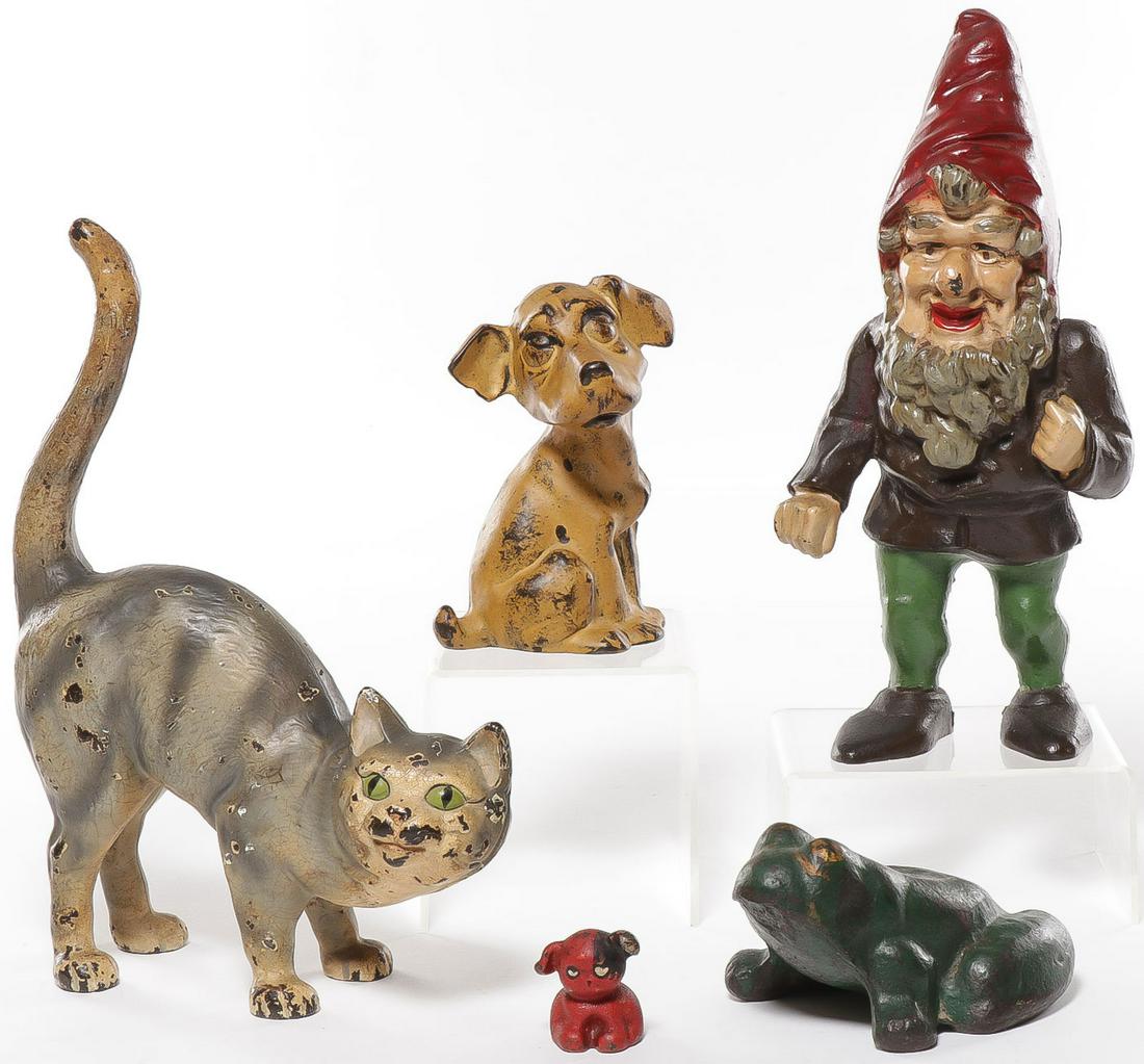 VINTAGE CAST IRON DOORSTOPS & MORE: VINTAGE CAST IRON DOORSTOPS & MORE. Comprising four polychrome cast iron doorstops including a scarce green-eyed cat, a seated puppy dog, a gnome, and a frog. Together with a scarce St. Louis Pup poly