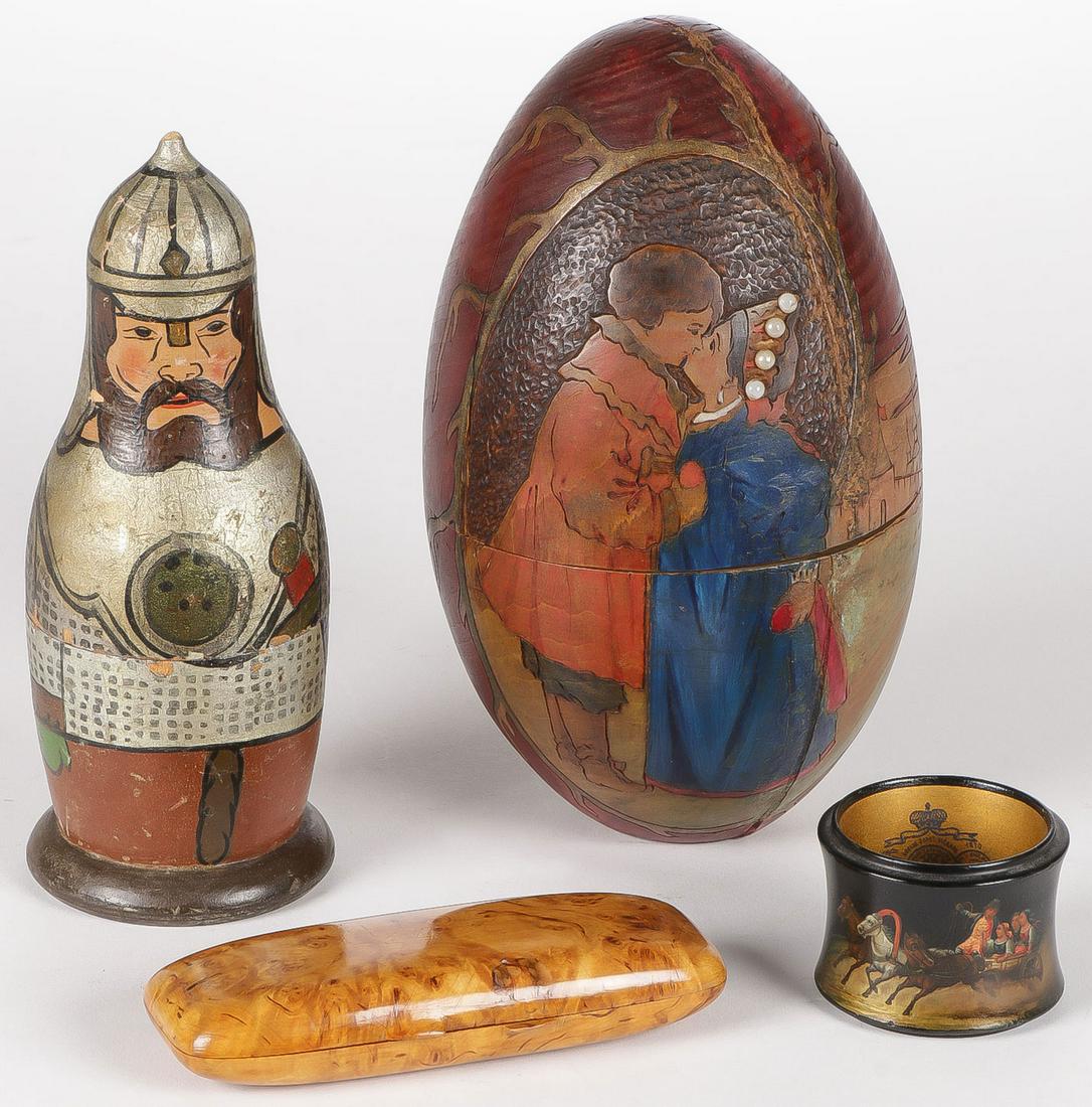 RUSSIAN KUSTAR GROUP C. 1900: RUSSIAN KUSTAR GROUP C. 1900. Comprising a two-piece soldier, a large polychrome and pyrography egg, a lacquer napkin ring with imperial warrant on the inside, and a Karelian Birch hinged cigar case. 