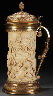 GERMAN CARVED IVORY AND GILDED SILVER TANKARD: A MASSIVE GERMAN CARVED IVORY AND GILDED SILVER MOUNTED TANKARD, 19TH CENTURY. The sides finely carved in high relief of an ancient battle scene with horses and elephants, probably depicting the battl