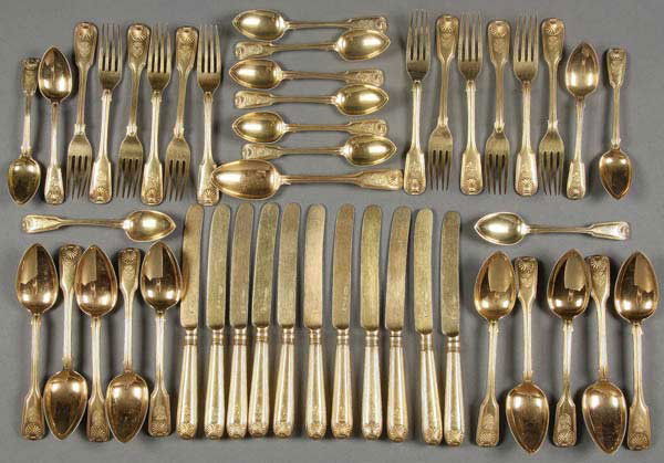 46-PC IMPERIAL RUSSIAN GILDED SILVER DINNERWARE: A 46 PIECE IMPERIAL RUSSIAN GILDED SILVER DINNERWARE SET, NICHOLS AND PLINKE, ST. PETERSBURG, CIRCA 1815. Comprising 12 teaspoons, 11 soup spoons, 12 forks, and 11 knives. The finial with inverted cla