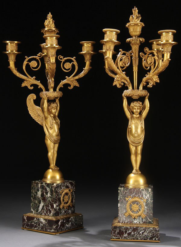 PR OF FRENCH EMPIRE REVIVAL GILT BRONZE CANDELABRA: A FINE PAIR OF FRENCH EMPIRE REVIVAL GILT BRONZE AND MARBLE CANDELABRA, CIRCA 1900. The finely sculpted and tooled winged figure with draped cloth supporting a rosette form wreath with extending scrol