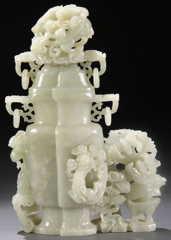 CHINESE CARVED WHITE JADE LIDDED URN, 19TH C.: A LARGE CHINESE CARVED WHITE JADE LIDDED URN, 19TH/20TH CENTURY. Carved with reticulated figural dragons, bats, fish and loose suspended rings in a pale celadon colored nephrite jade. Height 9.25 inch