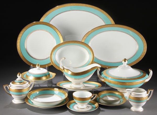 A 98 PIECE SERVICE OF PIRKENHAMMER CZECH "MILANO": A 98 PIECE SERVICE OF PIRKENHAMMER CZECH "MILANO" GOLD ETCHED PORCELAIN DINNERWARE, EARLY 20TH CENTURY. Seven piece place setting for 12 with scrolled gold etched foliate rims on a turquoise ground wi