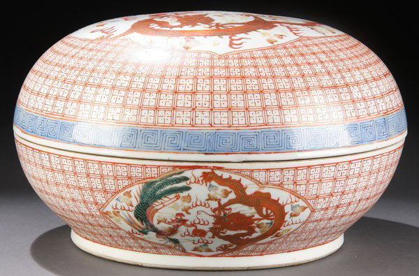 A CHINESE LIDDED CONTAINER, QING DYNASTY: A CHINESE LIDDED CONTAINER, QING DYNASTY. Red oxide dragon and gilt tracery with apocryphal Qianlong mark. Diameter 10.5 inches (26.5 cm).