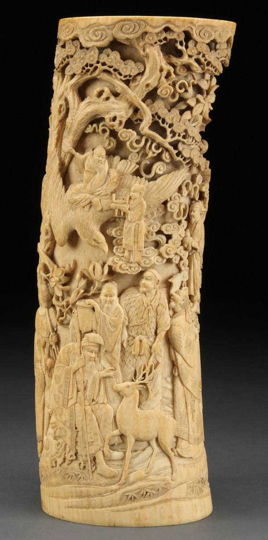 A LARGE CHINESE CARVED IVORY TUSK VASE, QING : A LARGE CHINESE CARVED IVORY TUSK VASE, QING DYNASTY/EARLY REPUBLIC PERIOD, profusely carved in deep relief and fine detail depicting an elaborate scene of immortals and attendants, one riding atop an