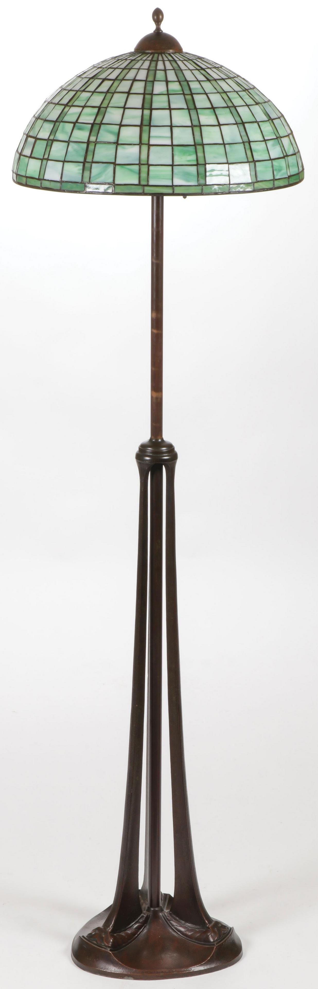 IMPRESSIVE HANDEL ADJUSTABLE FLOOR LAMP: IMPRESSIVE HANDEL ADJUSTABLE FLOOR LAMP. The bronze base (signed on underside) with three legs and central column supporting an adjustable shaft, with side screw lock and terminating with five Hubbell