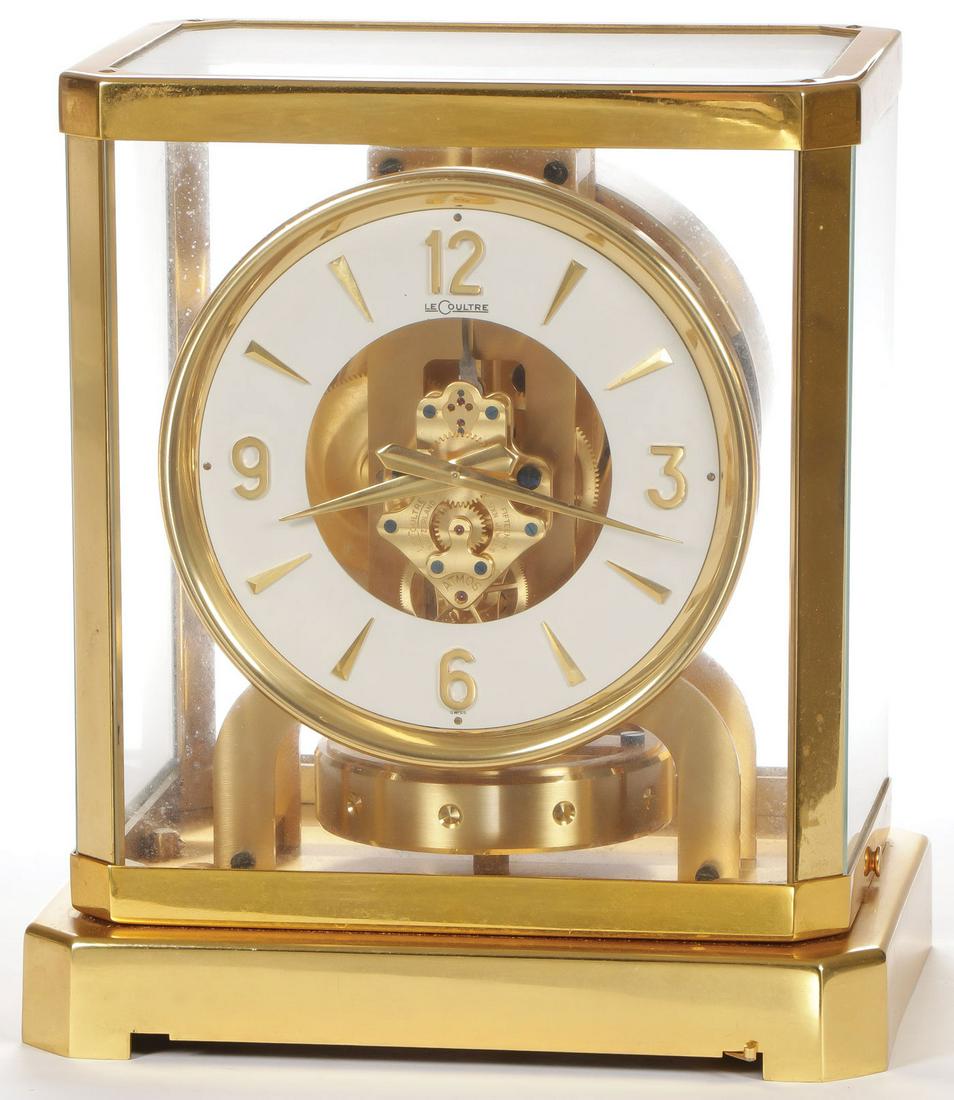ATMOS SWISS LECOULTRE CLOCK: ATMOS SWISS LECOULTRE CLOCK. Of traditional form with white open face. Serial number 26880. Height 9.25 inches. SHIPPING NOTICE: Jackson's is your sole and only source for one stop packing and shippin