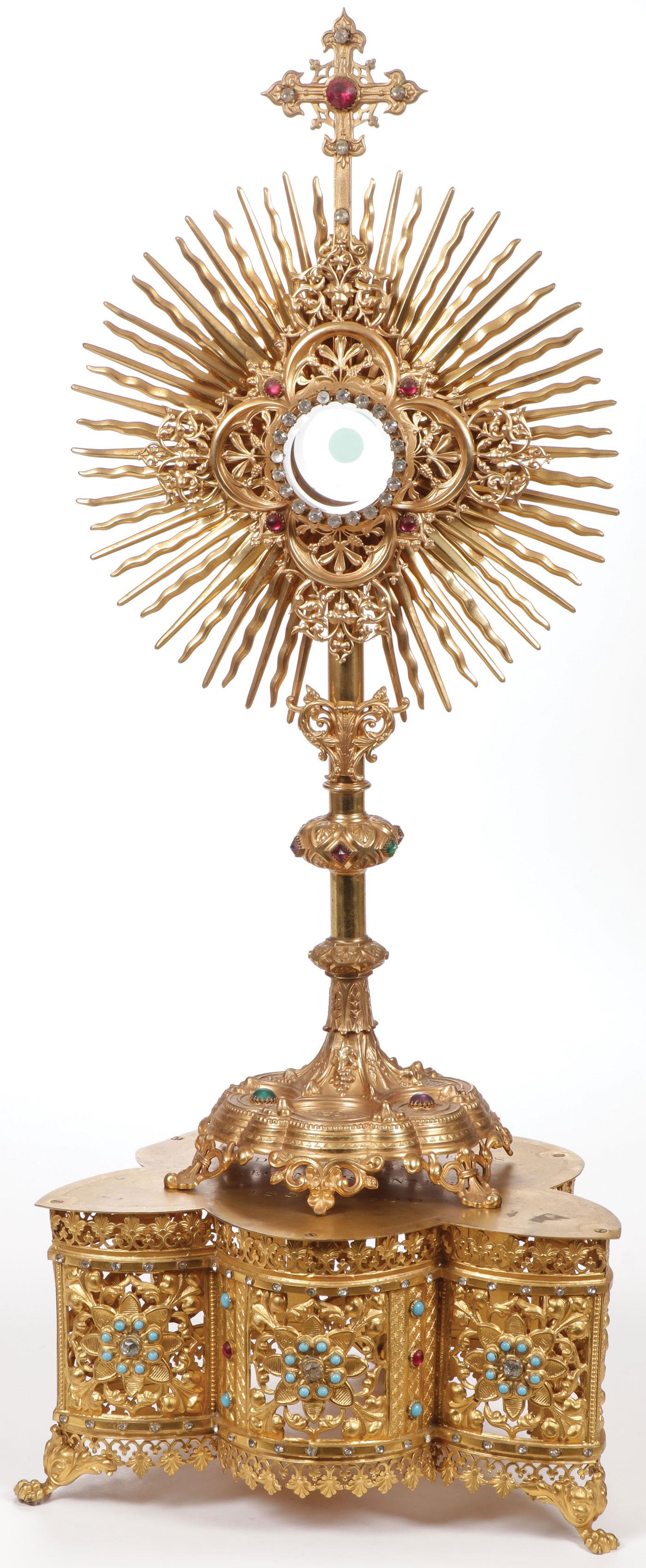 A GILT METAL MONSTRANCE AND TABOR: A GILT METAL MONSTRANCE AND TABOR. Comprising a gilt Friedrich Pustet marked monstrance on three footed lobed base with paste stone mounted central node and sunburst frame around central exposition wi