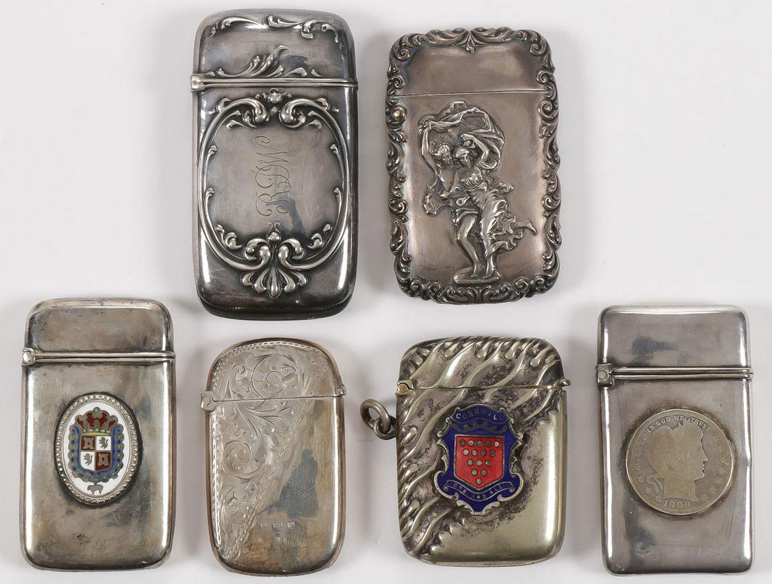 STERLING SILVER MATCH SAFES: STERLING SILVER MATCH SAFES. Comprising four sterling marked match safes and two others unmarked but likely sterling, including two examples with applied enameled plaques, one with an applied coin dat