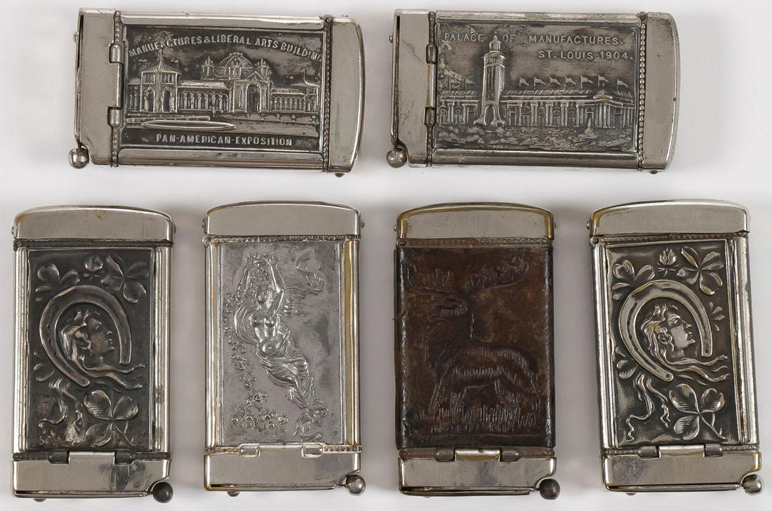 SIX VINTAGE MATCH SAFES: SIX VINTAGE MATCH SAFES. Each with cigar cutter incorporated into base various themes including: Pan American exposition, Buffalo, St. Louis exposition 1904, as well as beauties, good luck charms, and