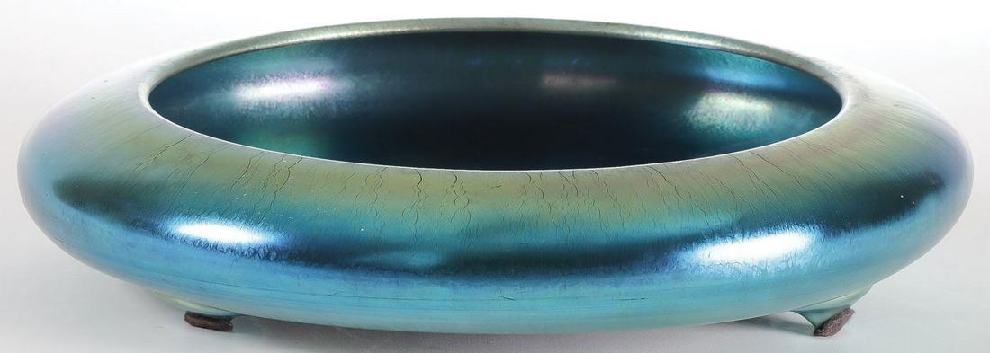 LARGE STEUBEN AURENE FOOTED BOWL #2586: LARGE STEUBEN AURENE FOOTED BOWL #2586. The blue aurene low bowl with closed-in rim, three applied feet, and polished pontil, etched on underside "AURENE and 2586." Height 2.75 inches, dia