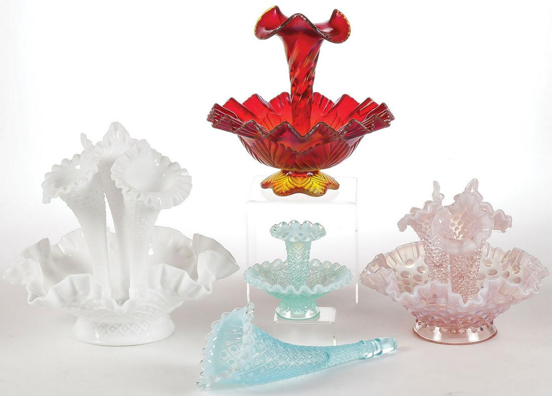 FOUR FENTON EPERGNES: FOUR FENTON EPERGNES. Of various composition and colors as shown and including one opalescent blue trumpet form solo insert. Greatest height 9.5 inches.SHIPPING NOTICE:Jackson's is your sole and