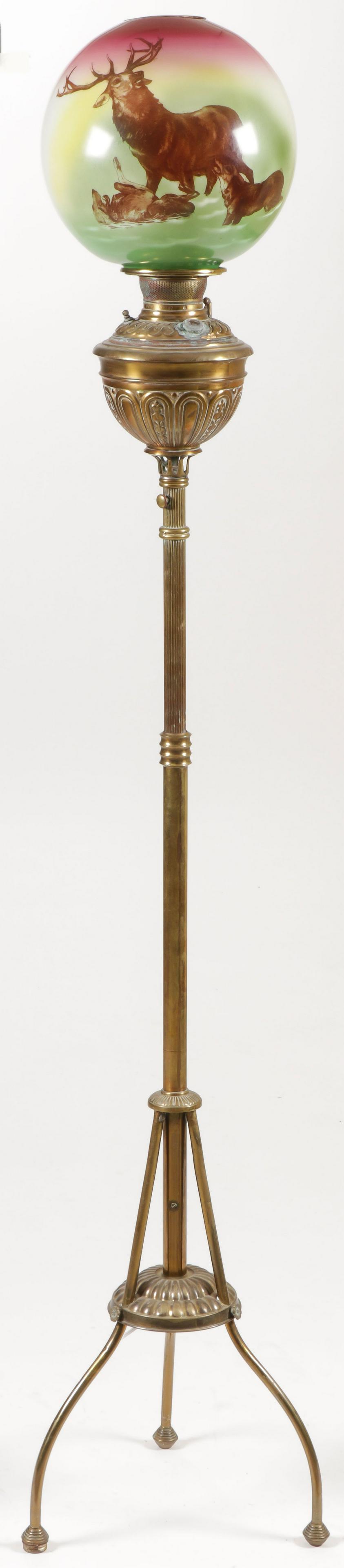 VICTORIAN BRASS ORGAN FLOOR LAMP: VICTORIAN BRASS ORGAN FLOOR LAMP. Raised on three feet with adjustable fluted central column and shade with wolves attacking a stag, electrified. SHIPPING NOTICE: Jackson's is your sole and only s