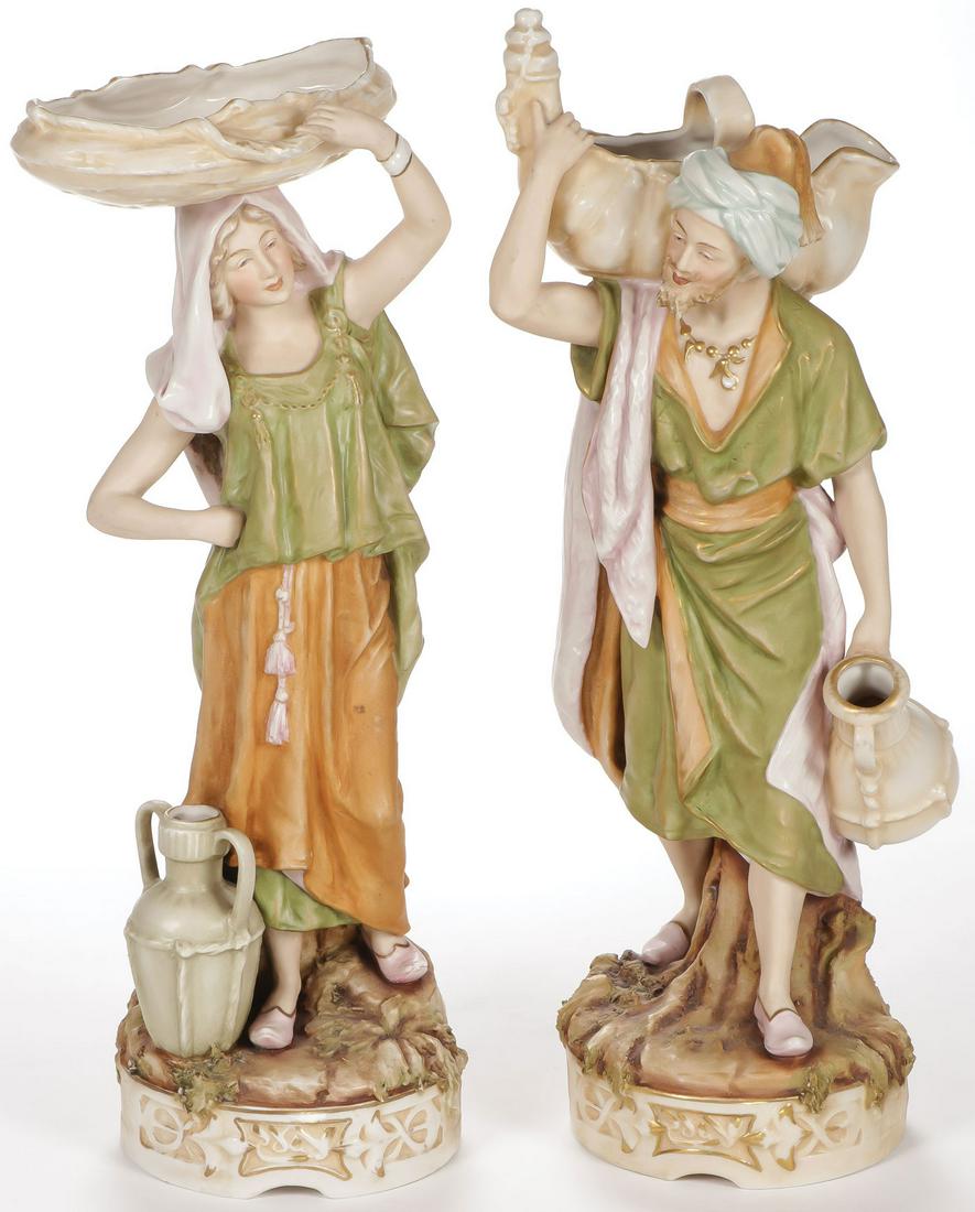 PAIR ROYAL DUX FIGURES "WATER CARRIERS": PAIR ROYAL DUX FIGURES "WATER CARRIERS". Comprising the man and woman "Eastern Water Carrier" figures, underside of each with pink triangular Royal Dux seal and impressed model numbers