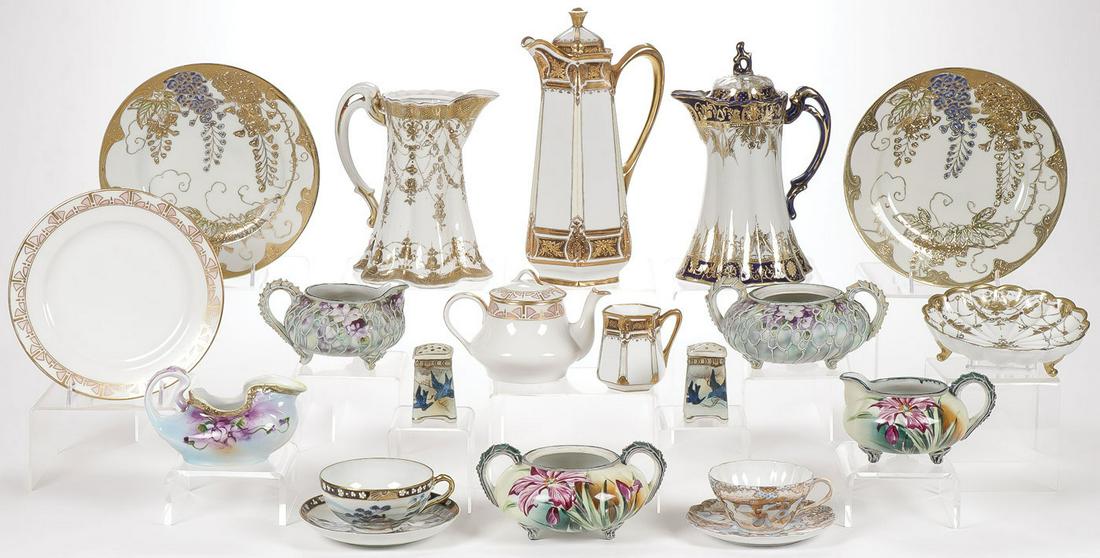 20 PIECES HAND-PAINTED PORCELAIN MOSTLY NIPPON: 20 PIECES HAND-PAINTED PORCELAIN MOSTLY NIPPON. Comprising over 20 individual pieces including creamers, sugars, chocolate pots, coffeepots, bowls and plates as shown. Including two beautiful gilt