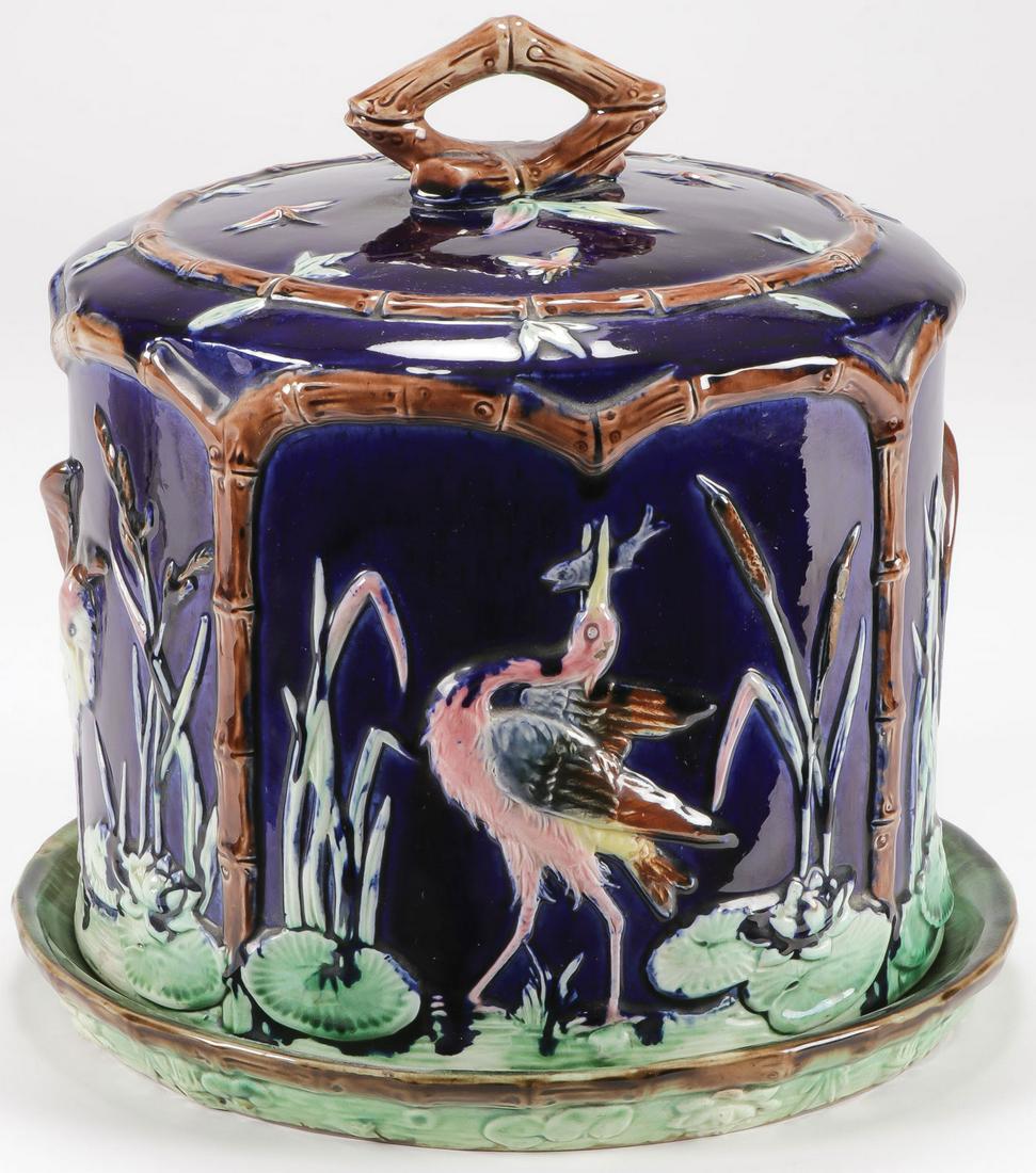 LOVELY ENGLISH MAJOLICA CHEESE DOME THOMAS FOREST: LOVELY ENGLISH MAJOLICA CHEESE DOME THOMAS FORESTER C. 1882. Majolica earthenware glazes depicting storks or cranes amongst lily pads and cattails with faux bamboo handled and original base. Heigh 10.