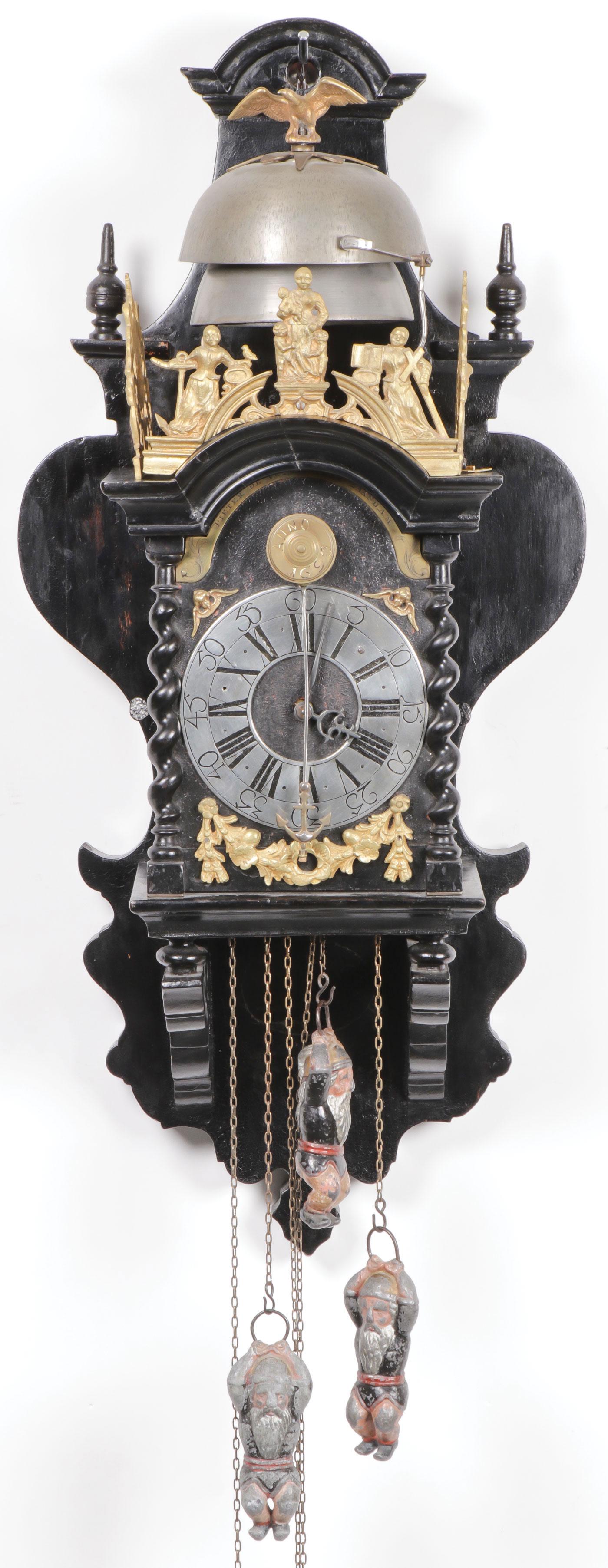 DUTCH ZAANSE WALL CLOCK 17TH/18TH CENTURY: DUTCH ZAANSE WALL CLOCK 17TH/18TH CENTURY. Of typical form with ornate cast bronze gallery depicting figures, double bell at top, polished dial and later gnome shaped weights. Movement is free and see