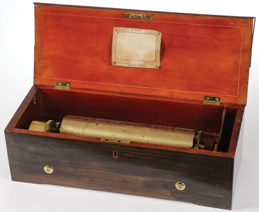 A SWISS NICOLE FRERES CYLINDER MUSIC BOX: A SWISS NICOLE FRERES CYLINDER MUSIC BOX. The rose wood case with inlaid hinged lid opening to reveal a twelve tune 13-inch cylinder, the sound board and comb both marked Nicole Freres and with origin