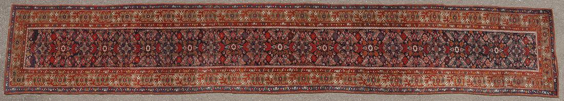 HANDWOVEN PERSIAN KURD FERAGHAN RUNNER, C. 1930: HANDWOVEN PERSIAN KURD FERAGHAN RUNNER, C. 1930. The navy ground with overall Herati design, having a dark blue outer border and soft green main border with stylized floral motif, 18 feet, 10 inches x