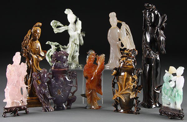CHINESE CARVED JADE, STONE & AMBER QUAN YIN GROUP: A CHINESE CARVED JADE, STONE AND AMBER QUAN YIN GROUP, 19TH/20TH CENTURY. Comprising a nephrite figure, large tiger-eye figure, rose quartz and agate figures, a large amber figure and a nephrite (repa