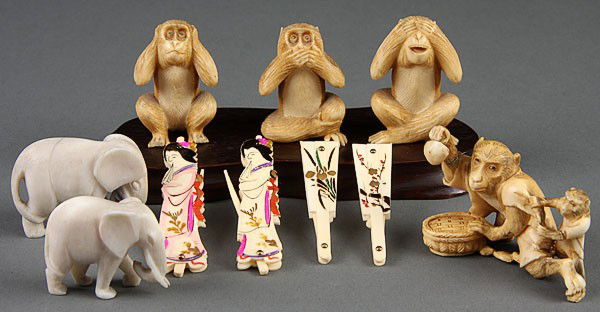 10 PIECE GROUP JAPANESE CARVED IVORY, EARLY20TH C: A TEN-PIECE GROUP OF JAPANESE CARVED IVORY, EARLY 20TH CENTURY, comprising a set of three wise monkeys, an anamorphic monkey figure, two elephants and four battledore form enameled folding toothpicks.