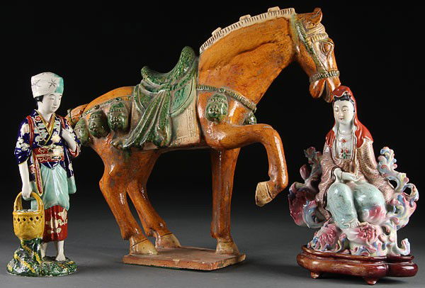 A CHINESE SANCAI GLAZED TANG STYLE HORSE, 20TH CE: A CHINESE SANCAI GLAZED TANG STYLE HORSE, 20TH CENTURY. Together with a famille rose Quan Yin and a Japanese glazed woman, some minor losses. Height 10.5 inches to 17 inches.