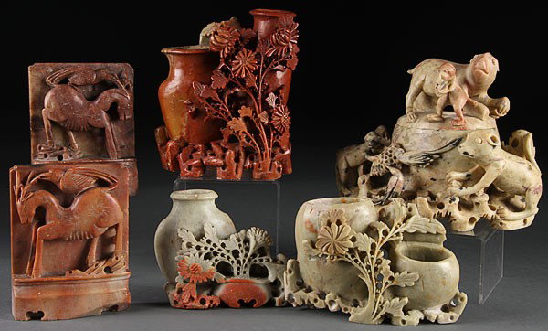 A SEVEN-PIECE CHINESE CARVED SOAPSTONE GROUP, EAR: A SEVEN-PIECE CHINESE CARVED SOAPSTONE GROUP, EARLY 20TH CENTURY, comprising a figural vase and floral grouping, mythical beast and vase grouping, and a pair of bookends with deer and bird figures, in
