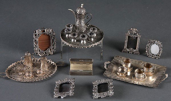 A MINI STERLING COFFEE/TEA SERVICE COLLECTION: A MINIATURE STERLING COFFEE/TEA SERVICE COLLECTION AND MINIATURE STERLING FRAME GROUP, EARLY 20TH CENTURY, comprising a Mexican silver butler's tray with cups and saucers, two coiled silver wire coffe