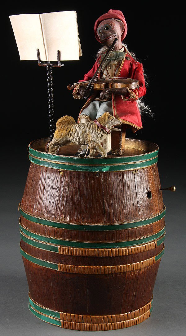 FRENCH MARQUIS MONKEY PLAYING VIOLIN AUTOMATON: A RARE FRENCH MARQUIS MONKEY PLAYING VIOLIN AUTOMATON, 19TH CENTURY. The mechanical animated monkey playing a violin with dog at feet atop a storage barrel with divided interior, probably marketed by 