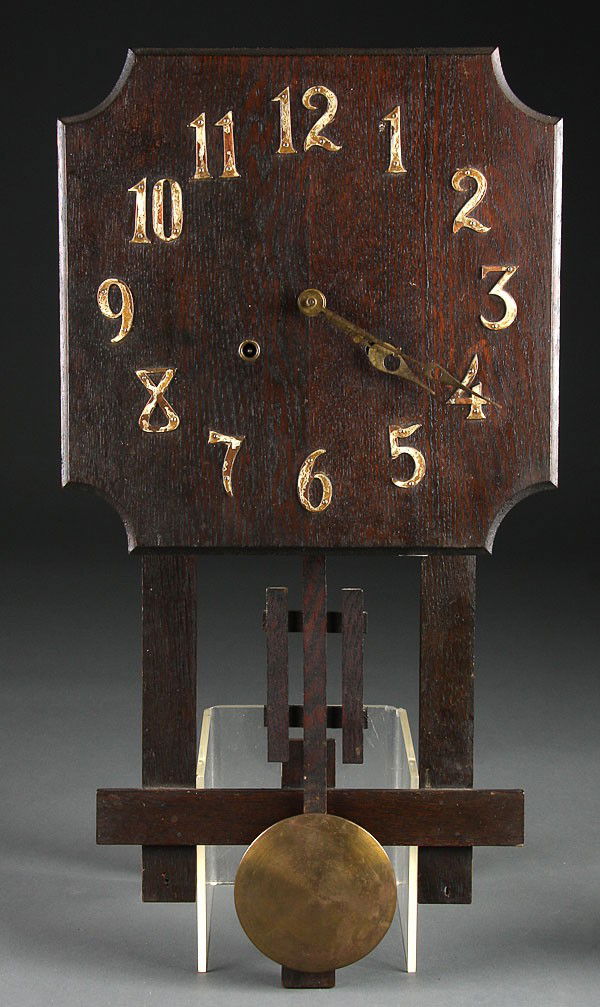 A MISSION STYLE OAK WALL CLOCK, CIRCA 1900. Heig: A MISSION STYLE OAK WALL CLOCK, CIRCA 1900. Height 26 inches.