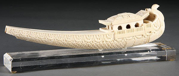 CARVED IVORY MODEL OF A DHOW: A CARVED IVORY MODEL OF A DHOW, 20TH CENTURY probably India, with figural bird's head bow and ornately carved hull and cabin. Some losses. Length 9.8 inches (25 cm).