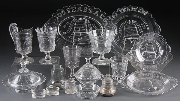 A 59 PC COLLECTION OF LIBERTY BELL PRESSED GLASS: A 59 PIECE COLLECTION OF CENTENNIAL AND BICENTENNIAL LIBERTY BELL PRESSED GLASS TABLEWARES, 19TH AND 20TH CENTURIES, consisting of four bread plates, six footed berry dishes and master berry bowl, cre
