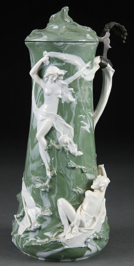 A GERMAN MARBLEIZED JASPERWARE FIGURAL JUG: A GERMAN MARBLEIZED JASPERWARE FIGURAL JUG, EARLY 20TH CENTURY. With sculpted scene of a shipwrecked sailor and nude rising from the waves. (Chip on base) Height 13.75 inches (35 cm).