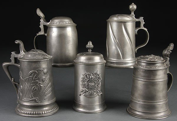 5 BEER STEINS GERMAN PEWTER BEER MILITARY: BEER STEINS, A GROUP OF FIVE GERMAN PEWTER BEER STEINS, LATE 19TH/EARLY 20TH CENTURY. Including embossed decoration in applied military armor design, named to Wolfgang Dorfler. The largest 7.25 inches