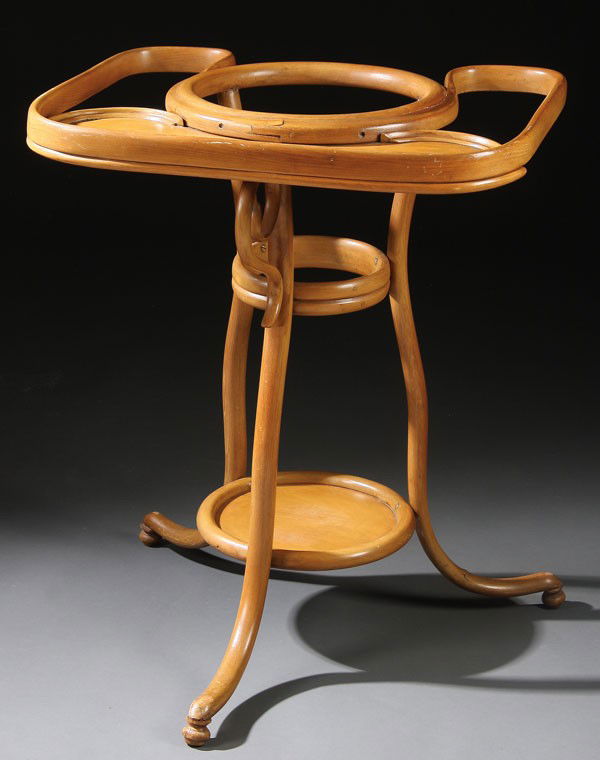 VICTORIAN BENT WOOD WASH STAND, LATE 19TH C: A VICTORIAN BENT WOOD WASH STAND, LATE 19TH CENTURY. With kidney-shaped shelf and conforming towel bars encircling a basin holder above shelf for pitcher, supported by three bent curved legs. Height 3
