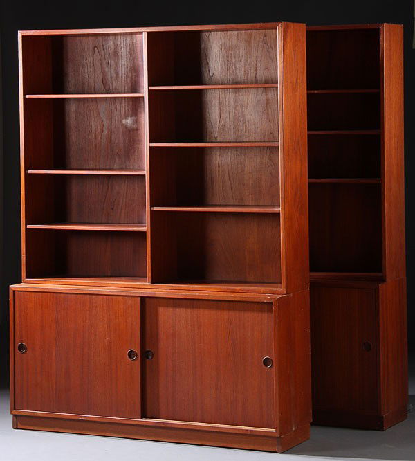 FINE DANISH MODERN BOOKCASES, BORGE MOGENSEN: A VERY FINE PAIR OF BORGE MOGENSEN FOR KARL ANDERSSON DANISH MODERN TEAK BOOKCASES ON CABINETS, CIRCA 1960. Each double section open bookcase with adjustable wood shelves atop a double cabinet base wi