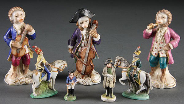 7 PORCELAIN FIGURES MONKEY BAND STITZENDORF: A SEVEN-PIECE CONTINENTAL PORCELAIN GROUP, EARLY 20TH CENTURY. Comprising three monkey band figures (losses and repairs) and four Stitzendorf Napoleonic figures. The largest 4 inches (10 cm).