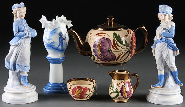 A VINTAGE PORCELAIN AND GLASS GROUP, 19TH/20TH C: A VINTAGE PORCELAIN AND GLASS GROUP, 19TH/20TH CENTURY. Comprising a pair of blue and white bisque Victorian skater figures, a Bohemian blue enameled vase and a three-piece wade "harvest" tea set (sug