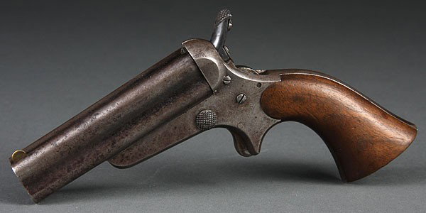 A SHARPS & HANKINS PEPPERBOX PISTOL, 3RD MODEL. F: A SHARPS & HANKINS PEPPERBOX PISTOL, 3RD MODEL. Forward sliding, breech loaded, walnut grips. Right side of frame marked C SHARPS PATENT JAN 25 1859. Top of barrel marked address SHARPS & HANKINS, PHI