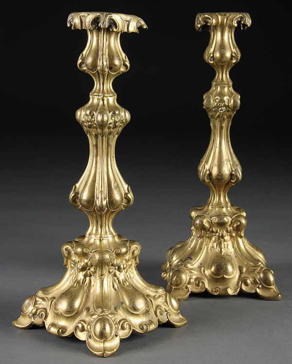 A PAIR OF M. JARRA BRASS JUDAICA CANDLESTICKS, LA: A PAIR OF M. JARRA BRASS JUDAICA CANDLESTICKS, LATE 19TH CENTURY, Krakow, Poland. Embossed scroll and foliate design. Stamped "M. Jarra." Height 12 inches.