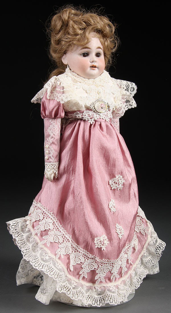 AN ARMAN MARSEILLE BISQUE SHOULDER HEAD DOLL. He: AN ARMAN MARSEILLE BISQUE SHOULDER HEAD DOLL. Height 18 inches.