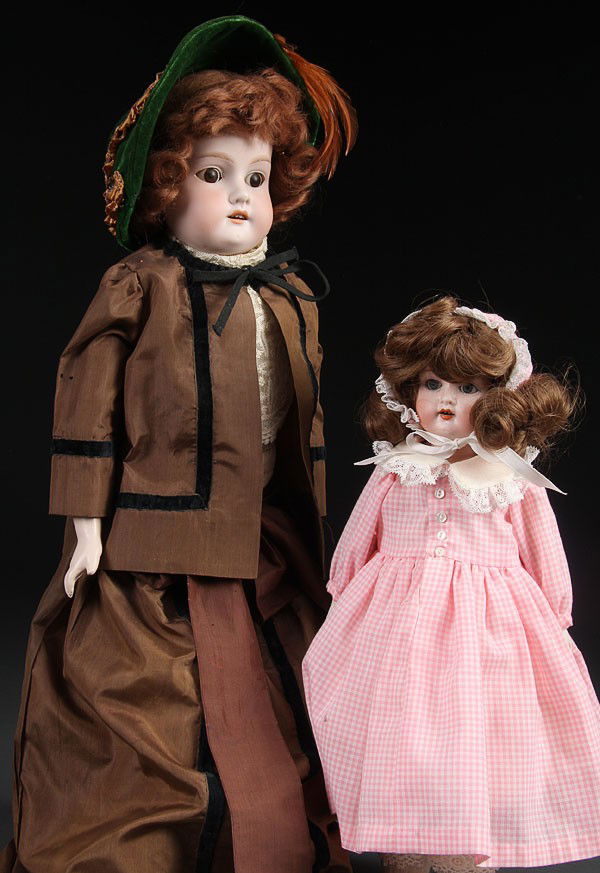 A PAIR OF GERMAN BISQUE DOLLS, EARLY 20TH CENTURY: A PAIR OF GERMAN BISQUE DOLLS, EARLY 20TH CENTURY. Consisting of An A&M bisque doll #370 with kid body, length 23 inches. Together with a Simon Halbig Bisque doll (M.O.A.). Length 15 inches.