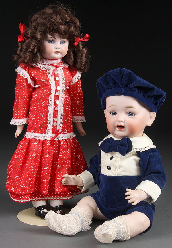 A JAPAN (NIPPON) ALL BISQUE TODDLER DOLL, length: A JAPAN (NIPPON) ALL BISQUE TODDLER DOLL, length 17 inches. Together with a reproduction Heubach bisque doll with kid body. Height 17.5 inches.