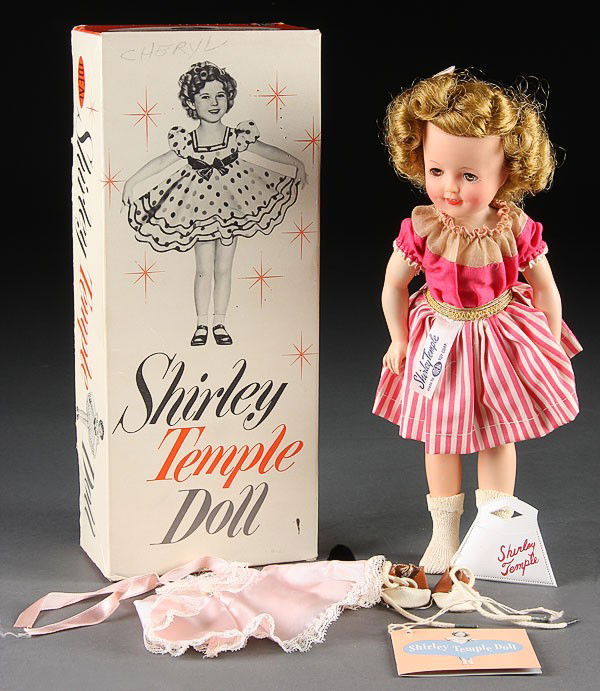 A VERY FINE IDEAL SHIRLEY TEMPLE CHARACTER DOLL,: A VERY FINE IDEAL SHIRLEY TEMPLE CHARACTER DOLL, MID-20TH CENTURY. Mint in original box, including original dress with Ideal label, pink bow in curly hair with hairpins intact, two pairs of shoes, add