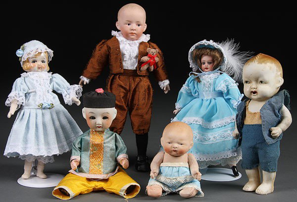FOUR SMALL VINTAGE ALL BISQUE DOLLS, including a : FOUR SMALL VINTAGE ALL BISQUE DOLLS, including a Grace Putnam baby. Length 5.5 inches to 7.75 inches. Together with a miniature bisque doll with glass eyes, German. Length 8.5 inches.