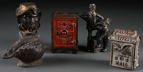 FIVE VINTAGE CAST IRON BANKS, EARLY 20TH CENTURY.: FIVE VINTAGE CAST IRON BANKS, EARLY 20TH CENTURY. Consisting of a two face black boy, a Shellout (missing cover), a letter box, safe and Mutt & Jeff figures. The largest height 5.25 inches.