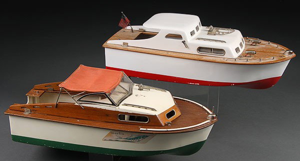 TWO JAPANESE BATTERY OPERATED CABIN CRUISER BOAT: TWO JAPANESE BATTERY OPERATED CABIN CRUISER BOAT TOYS, MID-20TH CENTURY. Plastic hulls with wood decks and cabins. One with inboard complete, other with outboard absent. Length 17 inches.