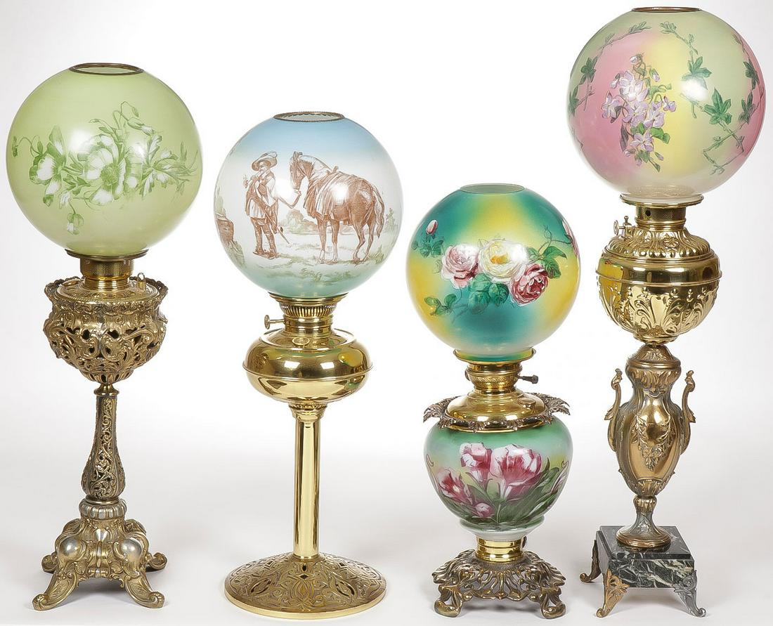 FOUR PARLOR AND BANQUET LAMPS: FOUR PARLOR AND BANQUET LAMPS. Each with different ornate bases, each electrified with the exception of the second lamp with horse and rider. Greatest height 31.5 inches. SHIPPING NOTICE: Jackson