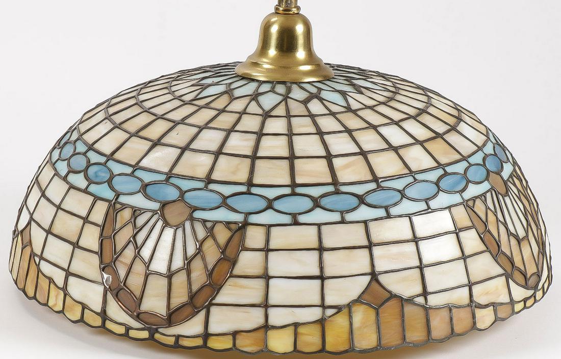 A VINTAGE LEADED GLASS HANGING SHADE: A VINTAGE LEADED GLASS HANGING SHADE. The dome shade with leaded slag glass geometric pattern and swags with original brass hardware and chain. Possibly Chicago Mosaic Company. The diameter of shade 2